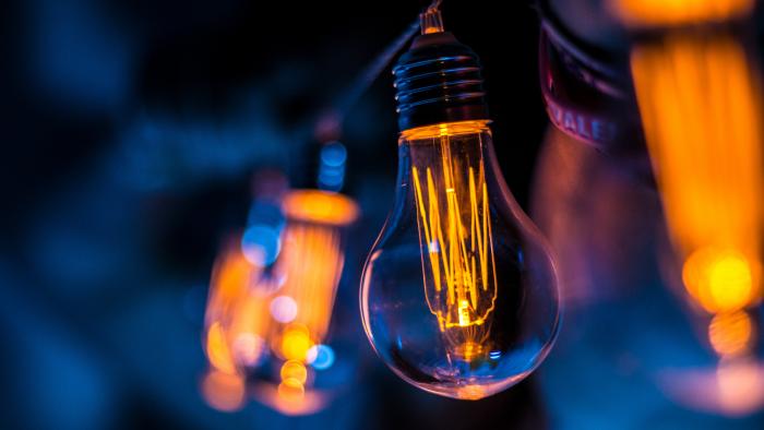 Orange and blue image of a filament lightbulb