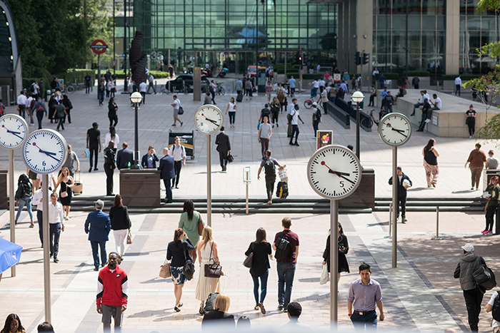 Commuters walk through Reuters Plaza, Canary Wharf